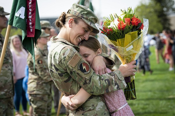 While they enjoy many advantages, military kids negotiate multiple schools, relocations and repeated deployments growing up. In this photo by Joshua Armstrong, U.S. Air Force Emily Adams embraces a family member following graduation from Preparatory School for the United States Air Force Academy.