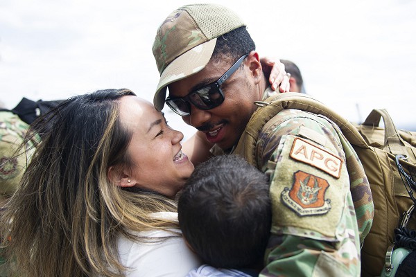 In this Air Force photo by Chris Farley, Staff Sergeant Darrell Anderson hugs his wife Felicia and son after returning from a three-month deployment to Europe. SSgt. Anderson is assigned to the 934th Airlift Wing, Minneapolis-St. Paul Air Reserve Station, Minnesota which deployed to Europe to practice tactical airlifts and aeromedical evacuations. Families like these learn to be resilient in the face of multiple relocations and long deployments overseas.