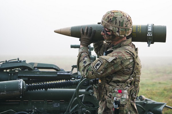 In this photo by Staff Sergeant John Yountz, a U.S. Army paratrooper assigned to 4th Battalion, 319th Field Artillery Regiment (Airborne) shoulders a round for the M777 Howitzer for an artillery capabilities fire demonstration during a leadership validation exercise at the U.S. Army Joint Multinational Readiness Center at Hohenfels, Germany. American Cannoneers provide close fire support for infantry units when lives are on the line.