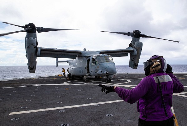 Philippine Sea (July 28, 2022): In this photo by Lance Corporal Yvonne Iwae, U.S. Navy Sailors assigned to the USS New Orleans transport supplies off an Osprey tilt-rotor aircraft in support of the Marine Corps 31st  Marine Expeditionary Unit. The 31st MEU is the only continuously deployed quick reaction force available for any combat or humanitarian crisis in the Indo-Pacific