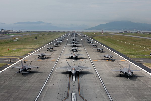 Marine Corps Air Station, Iwakuni, Japan. (August 23, 2022): In this photo by Staff Sergeant Jessika Braden, the U.S. Air Force 354th Air Expeditionary Wing and the U.S.M.C. Aircraft Group 12 demonstrate their capabilities during a readiness exercise here this week.  The demonstration included five Marine Corps F/A-18 Hornets, eight F-35B Lightning II’s, a KC120J Super Hercules, ten Air Force Raptors and ten F-35A Lightning II’s showcasing their high level of readiness to respond to any crisis that threatens a free and open Indo-Pacific.