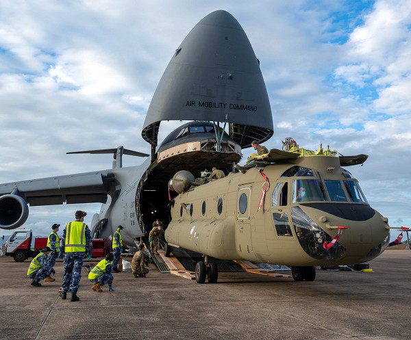 Townsville, Australia. (August 26, 2022): In this photo by Senior Airman Faith Schaefer, a U.S. CH-47F Chinook helicopter is unloaded from C-5 Super Galaxy transport plane at Royal Australian Air Force Base, Townsville, Australia as part of the Defense Department’s Foreign Military Sales Program.  The U.S. and Australia maintain a robust relationship based upon shared democratic values and a devotion to freedom and democracy.  This strong alliance is key to the peace and stability in the Indo-Pacific to counter territorial designs by China.