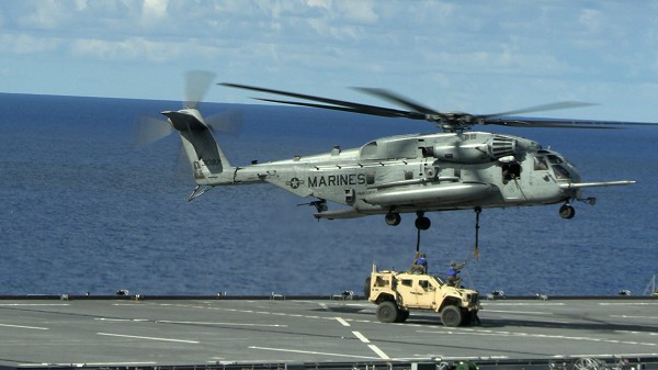 Philippine Sea. (September 9, 2022): In this photo by Lance Corporal Christopher England, a U.S. Marine CH-53S Super Stallion , with the Marine Medium Tiltrotor Squadron 262, 31st Marine Expeditionary Unit, is attached to a joint light tactical vehicle by Marines from Combat Logistics Battalion 31 aboard the USS Miguel Keith in the Philippine Sea. This exercise proves the Marines can bring heavy equipment into the most remote areas while operating aboard ships from the Tripoli Amphibious Ready Group.