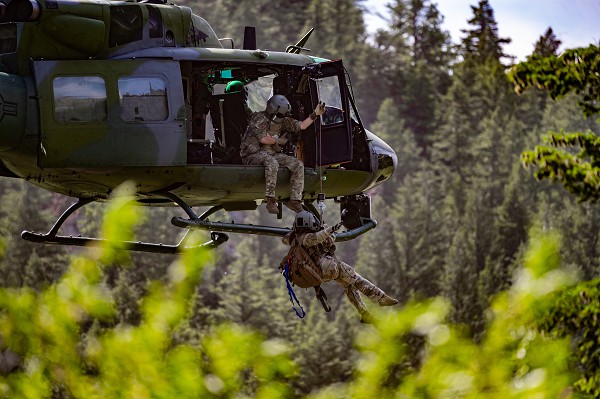 Sluice Boxes State Park, Montana. (September 10, 2022): In this photo by Airman 1st Class Mary Bowers, Tech. Sergeant Alex Landers, a flight engineer with the 40th Helicopter Squadron, lowers 341st Medical Group flight doctor Major Joyanne Tesei during search and rescue missions at Sluice Boxes State Park, Montana.  The “Old Reliable” UH-1H Huey helicopter, which was the Army’s mainstay during the Viet Nam War, is still in service rescuing downed pilots today.