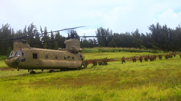 Training Area Kahukus, Hawaii. (September 13, 2022):  In this photo by Corporal Alex Kouns, Marines assigned to Lima Company, 3rd Battalion, 3rd Marine Regiment, 3rd Marine Division exit a CH-47 Chinook helicopter. The Chinook is celebrating 50 years in the air and the Army plans to keep them flying for another 50 years. What a remarkable bird!