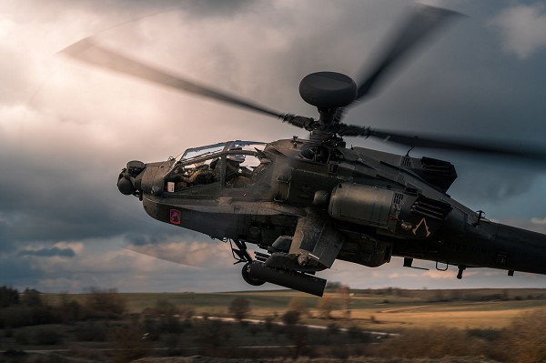 Grafenwohr Training Area, Germany. (September 7, 2022): In this photo by Major Robert Fellingham, Chief Warrant Officers Max Wannelius and Laura Chmielowski, AH-47 pilots assigned to the 12th Combat Aviation Brigade circle their Apache Longbow to re-attack targets during aerial gunnery practice at Grafenwohr Training Area. Produced by McDonnell Douglas’s plant at Mesa, Arizona, the Apache was designed to be a tough survivor in combat because of its advanced target acquisition and night vision capabilities.