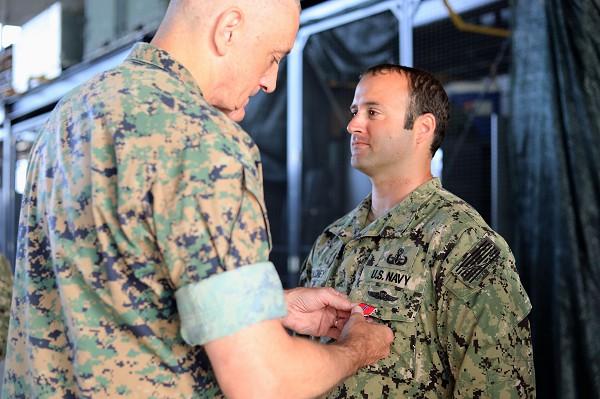 Naval Station Rota, Spain. (September 22, 2022): In this photo by Seaman Julleos Fernandez, Major General David Coffman, Director of Expeditionary Warfare, presents the Bronze Star Medal to Explosive Ordnance Disposal Technician Senior Petty Officer Joseph L. Maloney for service while deployed in support of Operation Inherent Resolve in Iraq.  The Bronze Star dates to World War II and is the fourth highest award a servicemember can receive for a heroic and meritorious deed in an armed conflict.  