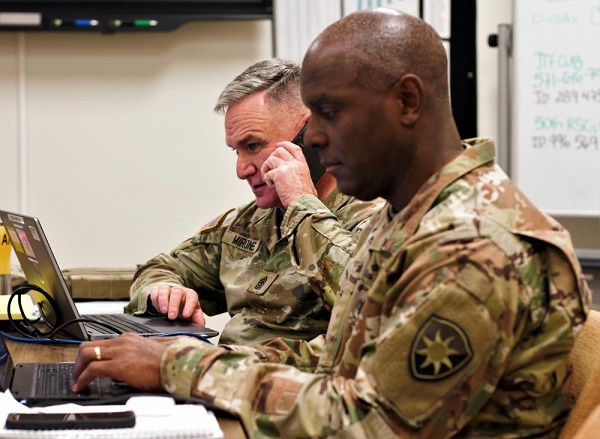 Homestead, FL. (October 1, 2022):  In this photo by Sergeant First Class Shane Klestinski, Army Sergeant Major Gregory Henson, right,  and Lieutenant Colonel Craig Henson of the 50th Regional Support Group make final plans for deploying Florida National Guard units to respond to Hurricane Ian. Thousands of well-disciplined troops deployed to the hardest hit counties, something these troops are eager to do.