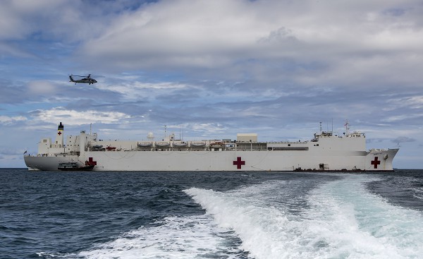 Padang, Indonesia. (October 19, 2020): In this photo by Royal Australian Air Force Corporal David Cotton, the Hospital Ship USNS Mercy sits anchored off the coast of Padang, Indonesia during Pacific Partnership exercises. The Mercy helps partner nations prepare for disasters by providing medical subject matter experts to help improve the capacity of local governments, civilian agencies, and partner militaries to collectively respond to crises.