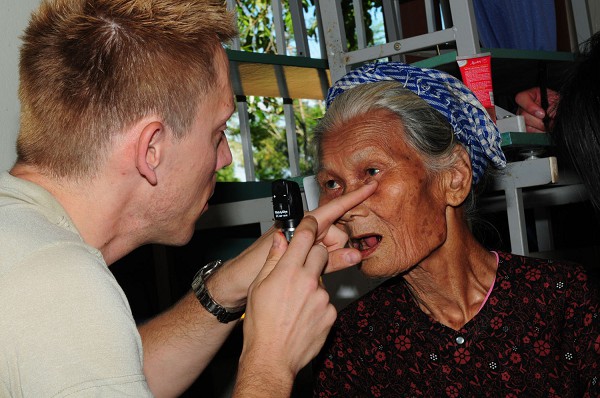 Quang Tri Province, Vietnam. (October 21, 2019): In this photo by Tech. Sgt. Kerry Jackson, Major (Doctor) Steven Tittl, an optometrist assigned to the 439th Aerospace Medical Squadron at Westover Air Reserve Base, Massachusetts examines a Vietnamese woman during Operation Pacific Angel exercises. Dr. Tittl and other U.S. Military servicemembers provided medical services and other humanitarian assistance to Quang Tri Province residents. 
