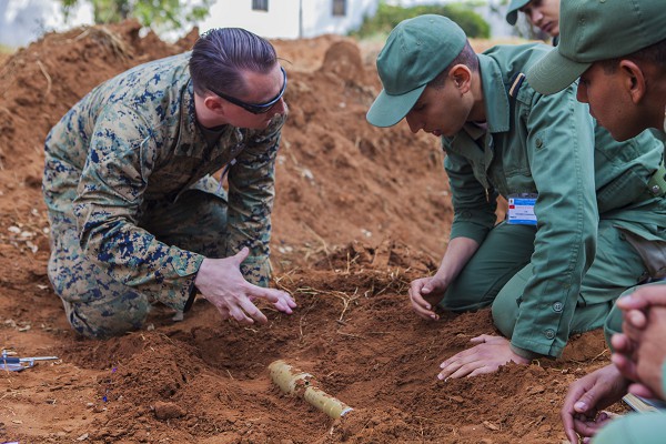 Kenitra, Morocco. (October 20, 2022): In this photo by Captain Clay Groover, a U.S. Marine with Special Purpose Marine Air-Ground Task Force Crisis Response teaches explosive ordnance identification procedures to a member of the Moroccan Royal Armed Forces. As part of its “Humanitarian Diplomacy”, the United States assists critical allies with intractable problems, in this case unexploded mines that threaten their civilian population.