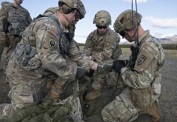 Joint Base Elmendorf-Richardson Alaska.(October 27, 2022): In this photo by Alejandro Pena, soldiers with the 4th Infantry Brigade Combat Team (Airborne), 25th Infantry Division recover a parachute during the sling load training portion of the U.S. Army’s Pathfinder qualifications course hosted by Joint Base Elmendorf-Richardson Alaska. The Army’s Pathfinder School, based at Ft. Benning, Georgia, sends instructors to various units around the world to conduct a three-week intensive course for soldiers who want to be “Always First.”