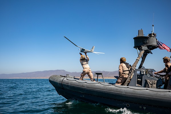 Camp Pendleton, CA. (October 22, 2022): In this photo by Staff Sergeant Connor Hancock, U.S. Marine Corps Corporal Thomas Rexrode launches an RQ-20B PUMA Small Unmanned Aircraft system from a rigid-hulled inflatable boat to test offshore reconnaissance capabilities.  Corporal Hancock is a Recon Marine assigned to A Company, 1st Recon Battalion, 1st Marine Division.