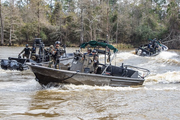 Stennis Space Center, MS. (February 22, 2022): In this photo by Michael Williams, Naval Small Craft Instruction and Technical Training School students from Estonia, Germany, Poland, and Romania participate in a Patrol Craft Officer Riverine training exercise on the Pearl River, Mississippi. This seven-week course is designed to provide international students with the knowledge and skills to operate a riverine patrol craft. To date, the school has trained more than 13,000 students from 120 partner nations.