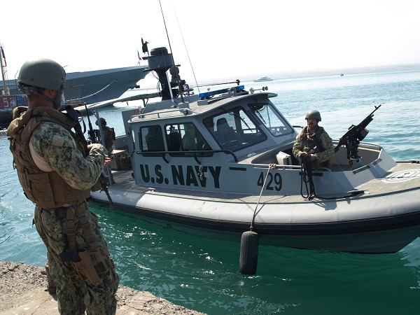 Republic of Djibouti. (November 9, 2022): In this photo by Master-at-Arms 2nd Class Perry Lafoe, Master-at-Arms 3rd Class Xavier Sierra, left, and Engineman 2nd Class Michael Shultz conduct a crew swap in port after a patrol mission.  The sailors are assigned to Coastal Riverine Squadron 10 under the U.S. 6th Fleet operating on the horn of Africa. Riverine sailors like these trace their heritage to the American Revolutionary War and none other than Benedict Arnold.