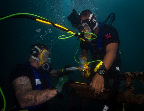 Pearl Harbor, HI. (July 21, 2022): In this photo by Navy Chief Eric Chan, a U.S. Navy diver and a Mexican navy diver participate in underwater construction activities as part Rim of the Pacific exercises involving 26 nations which is the largest maritime training event held each year.  The Navy’s Mobile Diving Salvage Unit 2, which normally operates in warm, deep-water environments, is training for underwater missions in the frozen Arctic.