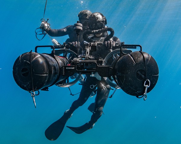 NORTHERN CALIFORNIA (Sept. 5, 2022) In this photo by MC2 Alex Perlman, Sailors assigned to various Naval Special Warfare (NSW) commands operate a Diver Propulsion Device (DPD) during high-altitude dive training. These devices allow combat divers to travel faster, and farther, underwater making them less fatigued when reaching their destination. The DPD greatly expands the speed and range of Navy divers during special operations missions.