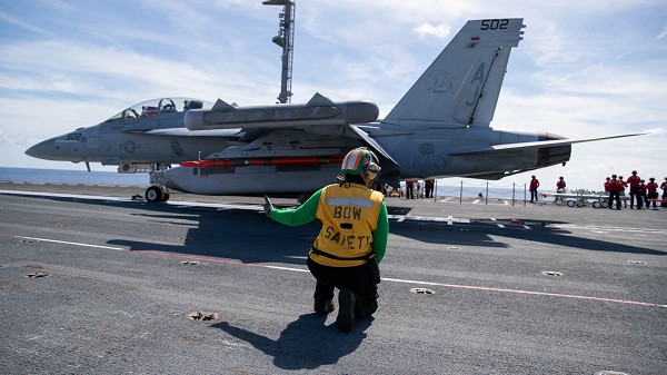 ATLANTIC OCEAN (Oct. 11, 2022): In this photo by MC3 Grant Gorzocoski, Aviation Boatswain’s Mate (Equipment) 2nd Class Lacarsha Mitchell, from Jacksonville, Fla., assigned to the first-in-class aircraft carrier USS Gerald R. Ford’s air department, signals safe to launch for an E/A-18G Growler, attached to the "Gray Wolves" of Electronic Attack Squadron142. The Gerald R. Ford Carrier Strike Group (GRFCSG) is deployed in the Atlantic Ocean, conducting training and operations alongside NATO Allies and partners. 