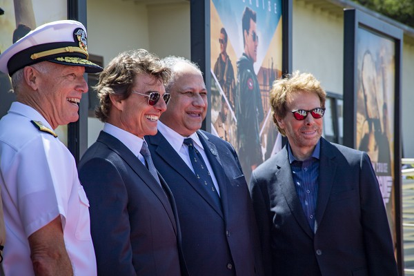 NAVAL AIR STATION NORTH ISLAND, Calif. (May 4, 2022): In this photo by MC2 Christina Ross, Vice Admiral Kenneth Whitesell, actor Tom Cruise, Secretary of the Navy Carlos Del Toro, and producer Jerry Bruckheimer meet on the red carpet for the advance premiere of Top Gun: Maverick on Naval Air Station North Island. Top Gun: Maverick features U.S. Navy and U.S. Marine Corps pilots and was shot on multiple ships and facilities including Naval Air Station Whidbey Island and the aircraft carriers USS Abraham Lincoln and USS Theodore Roosevelt.