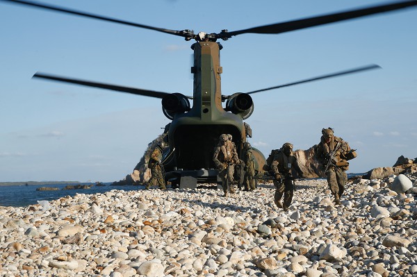 Tsutara, Japan. (November 16, 2022): In this photo by Corporal Scott Aubuchon, U.S. Marines with the 1st Battalion, 2nd Marines and members of the Japan Self Defense Forces Amphibious Rapid Deployment Brigade offload a CH-47 Chinook helicopter during Keen Sword exercises at Tsutara, Japan. Keen Sword exercises are a biannual affair that tests the combined lethality of the U.S. 3rd Marine Division’s 3rd Marine Expeditionary Force and Japan’s Self Defense Forces. The goal is to ensure interoperability among forces while increasing readiness of the U.S./Japanese Alliance.